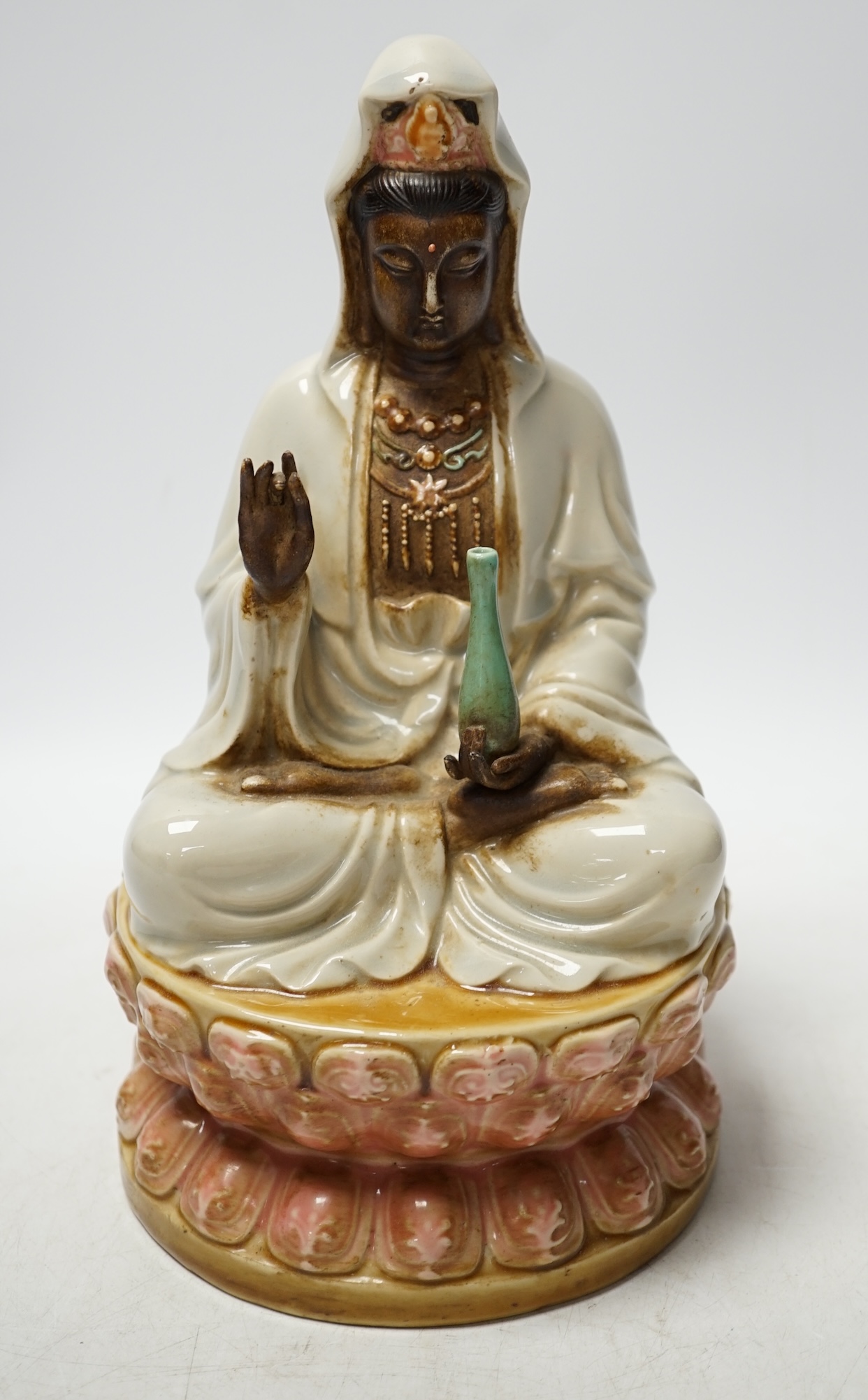 A Chinese enamelled porcelain figure of Guanyin, 19th century, 25cm high. Condition - fair